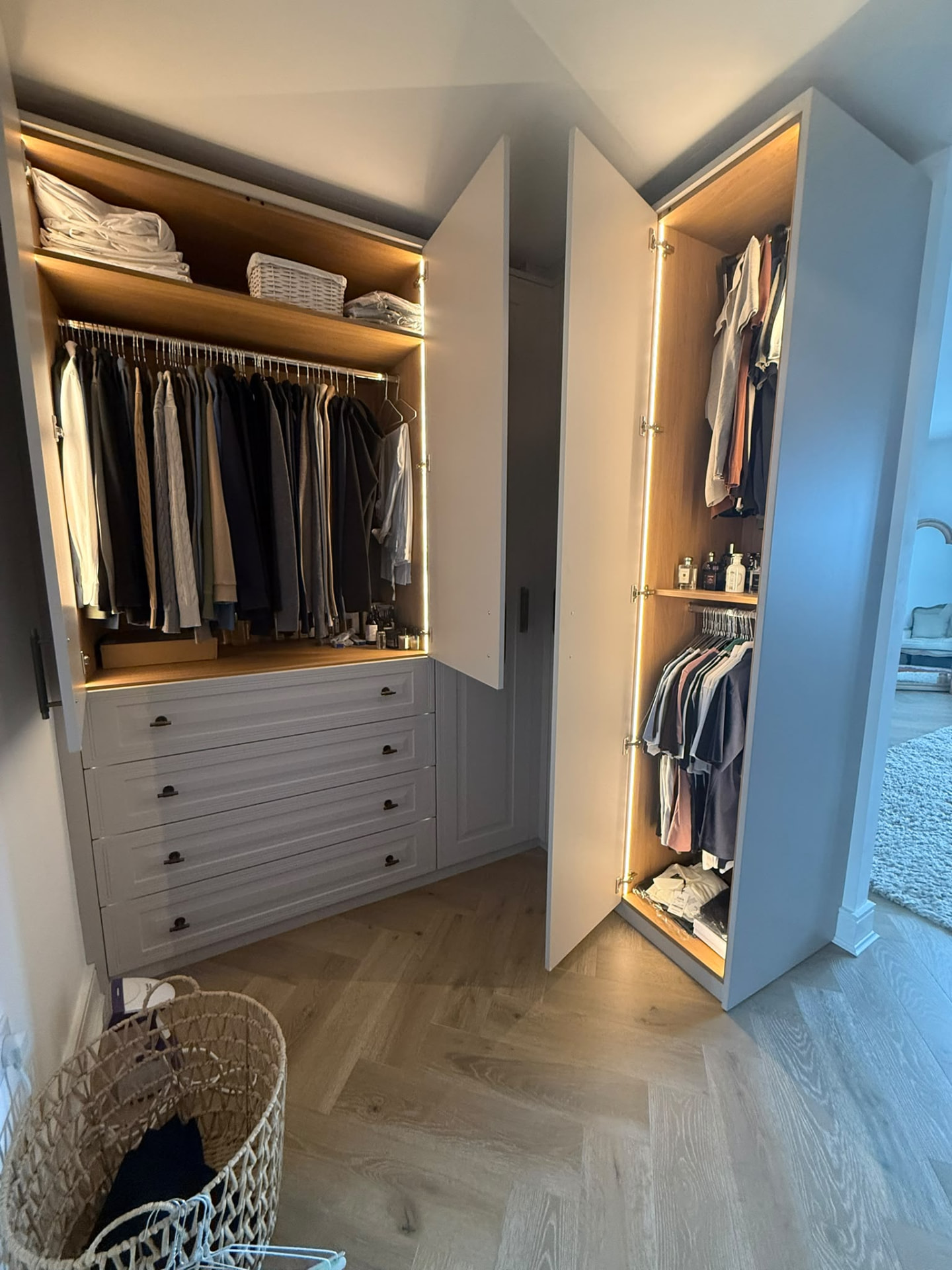 Fitted wardrobes with oak interiors, illuminated hanging space and built-in drawer stacks